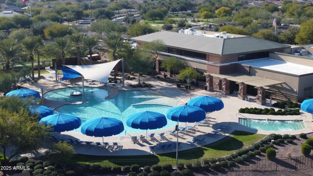 pool featuring fence, a water slide, and a patio area