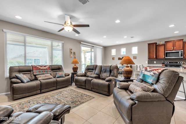 living room with light tile patterned flooring, recessed lighting, and a ceiling fan
