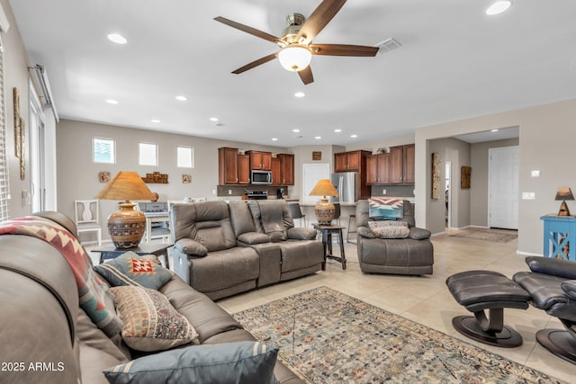 living room featuring light tile patterned floors, baseboards, visible vents, ceiling fan, and recessed lighting