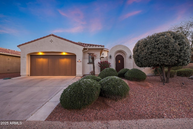 mediterranean / spanish-style home with a garage