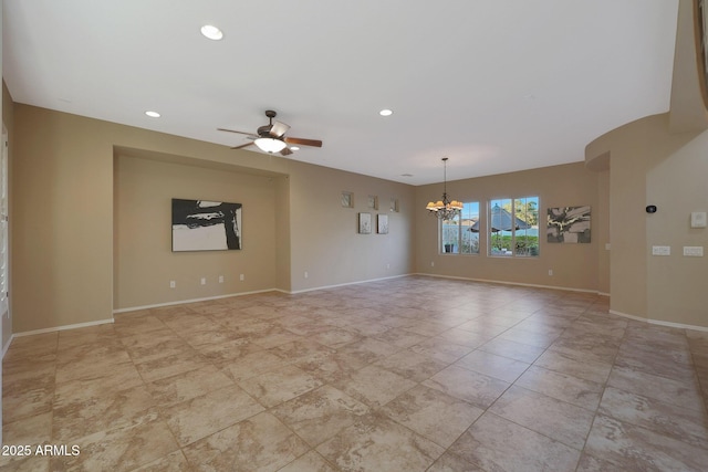 unfurnished room with ceiling fan with notable chandelier