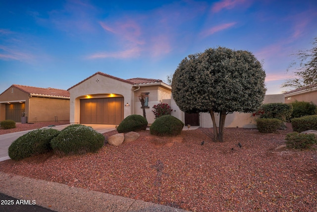 mediterranean / spanish-style house featuring a garage