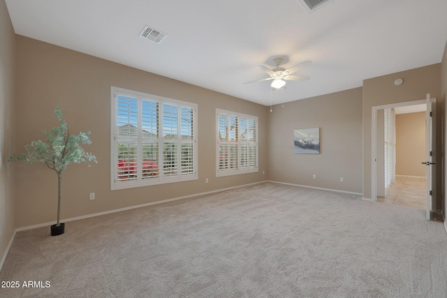 unfurnished room with ceiling fan and light carpet