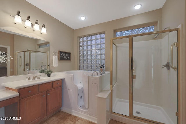 bathroom featuring a shower with door and vanity