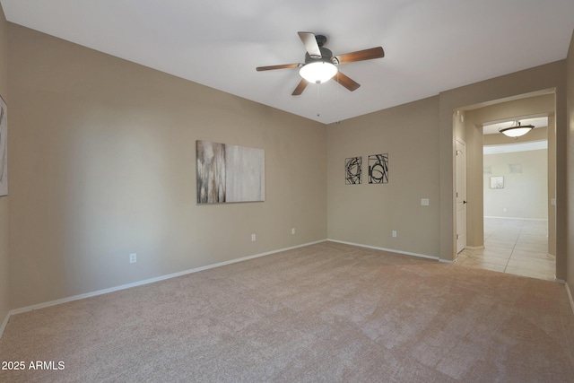 spare room featuring ceiling fan and light colored carpet