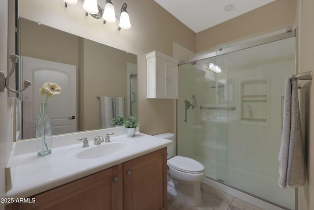 bathroom with toilet, walk in shower, vanity, and tile patterned flooring