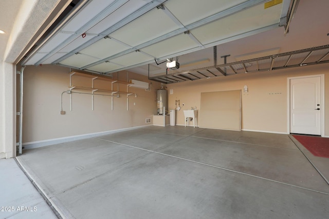 garage featuring water heater and a garage door opener