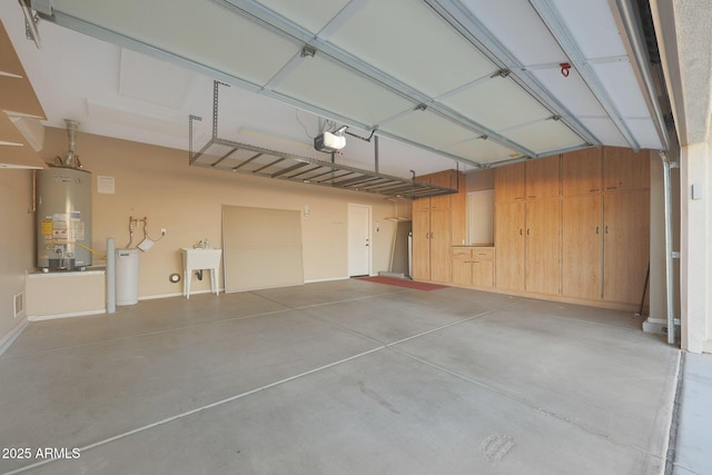 garage with sink, a garage door opener, and gas water heater