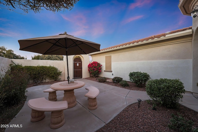 view of patio terrace at dusk