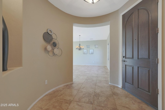 foyer with a chandelier