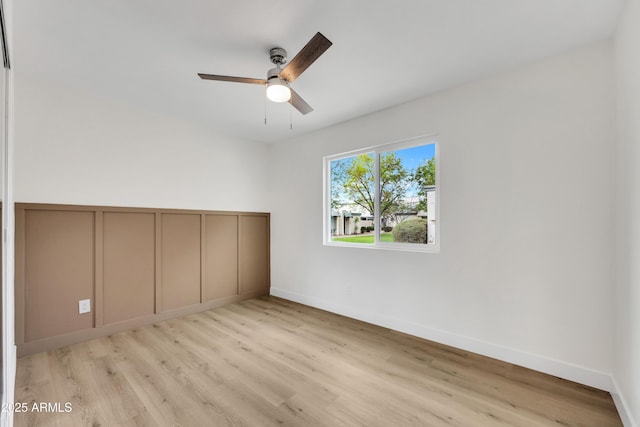 unfurnished bedroom with light wood-type flooring, ceiling fan, and baseboards