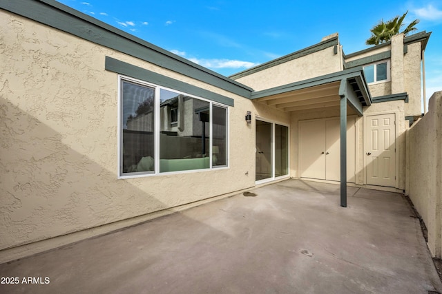 exterior space with a patio and stucco siding