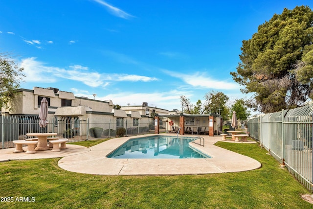 view of swimming pool featuring a yard, a patio area, a fenced backyard, and a fenced in pool