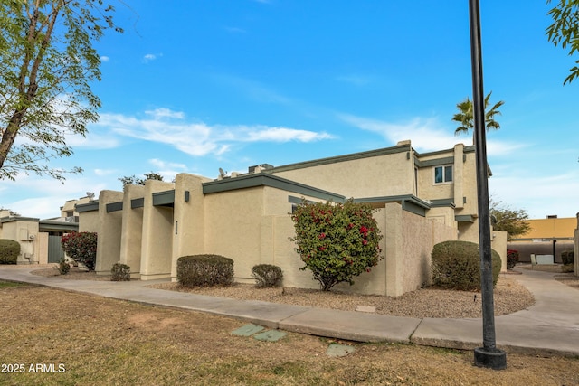 view of side of home featuring stucco siding