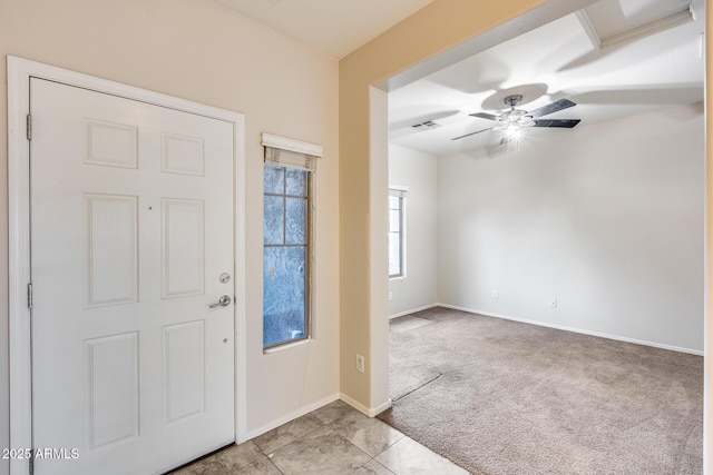 carpeted entrance foyer featuring ceiling fan