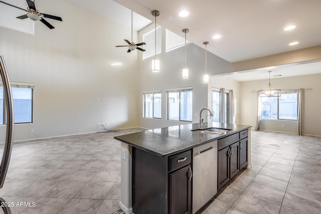 kitchen with ceiling fan, a kitchen island with sink, dishwasher, and sink