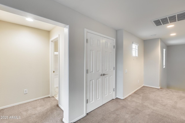 interior space with carpet floors, baseboards, visible vents, and recessed lighting