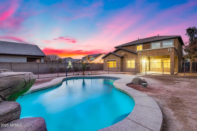 pool at dusk with a fenced backyard, a fenced in pool, and a patio