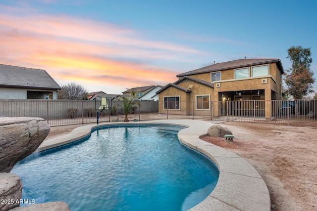 view of pool at dusk