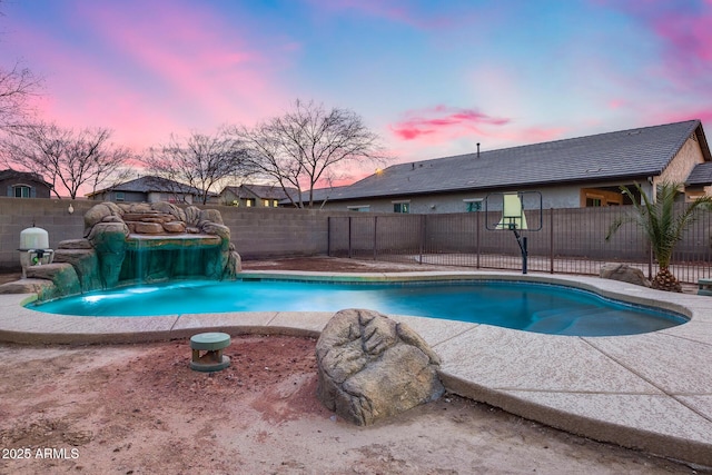 pool at dusk with pool water feature