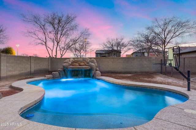 pool at dusk with pool water feature