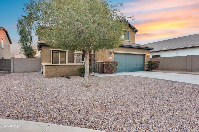 view of property hidden behind natural elements featuring fence, driveway, an attached garage, and stucco siding