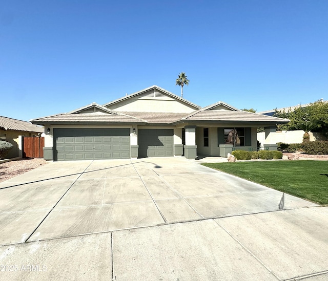 view of front of property with a garage and a front lawn