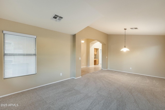 empty room with vaulted ceiling and light carpet