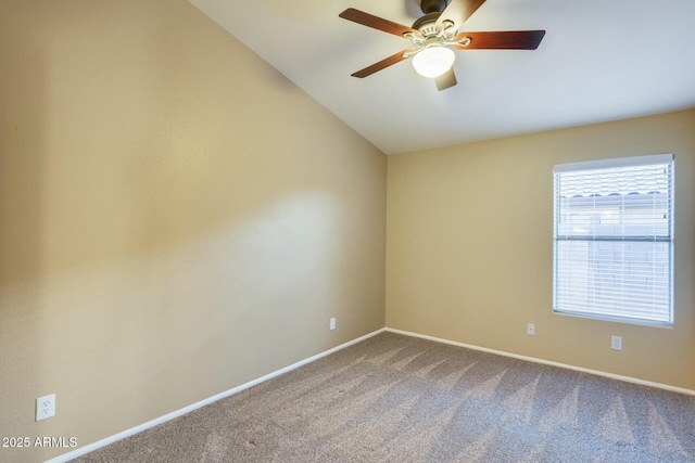 carpeted empty room with vaulted ceiling and ceiling fan