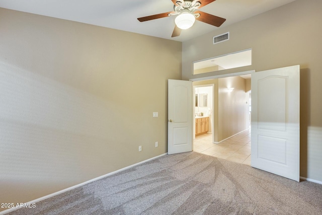 unfurnished bedroom with light colored carpet and ceiling fan