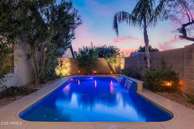 view of pool at dusk