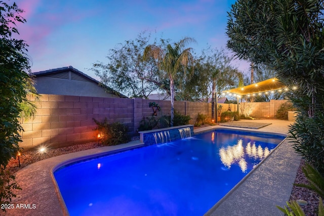 pool at dusk with pool water feature