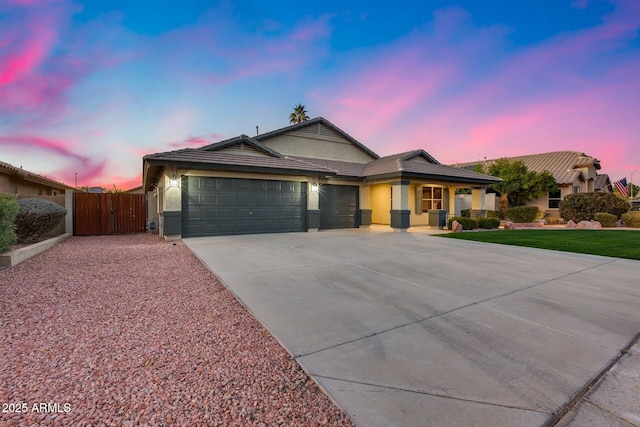 view of front of house featuring a garage and a lawn