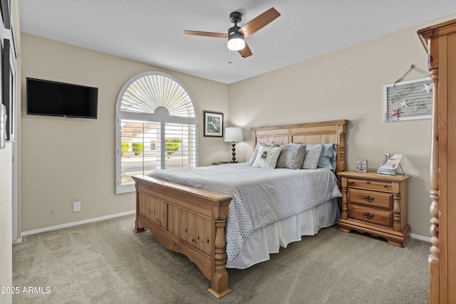 bedroom featuring baseboards, ceiling fan, and light carpet