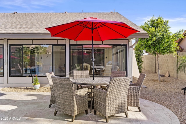 view of patio featuring fence and outdoor dining space