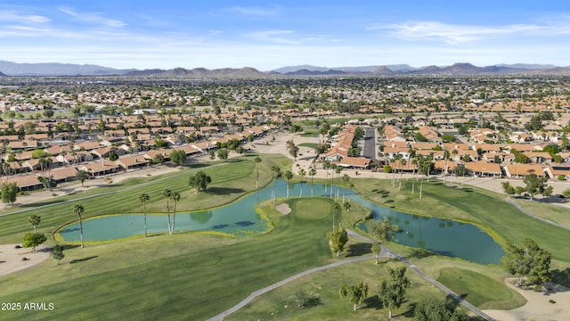 bird's eye view with view of golf course, a residential view, and a water and mountain view