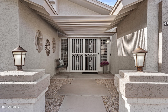 entrance to property with stucco siding