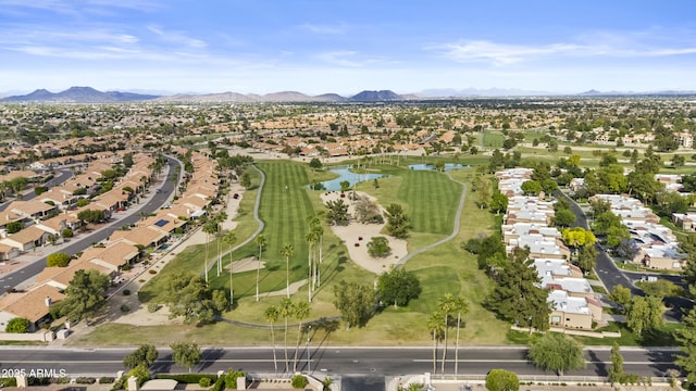 birds eye view of property featuring a water and mountain view, view of golf course, and a residential view