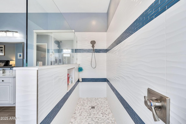 bathroom featuring vanity and a walk in shower