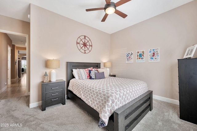 bedroom featuring a ceiling fan, light colored carpet, and baseboards