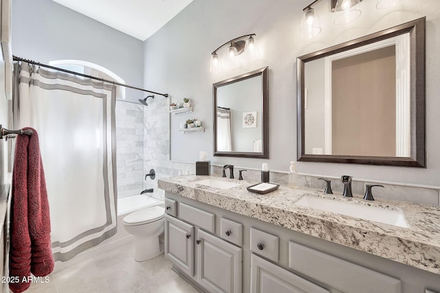 full bath with double vanity, toilet, shower / bath combo, and a sink