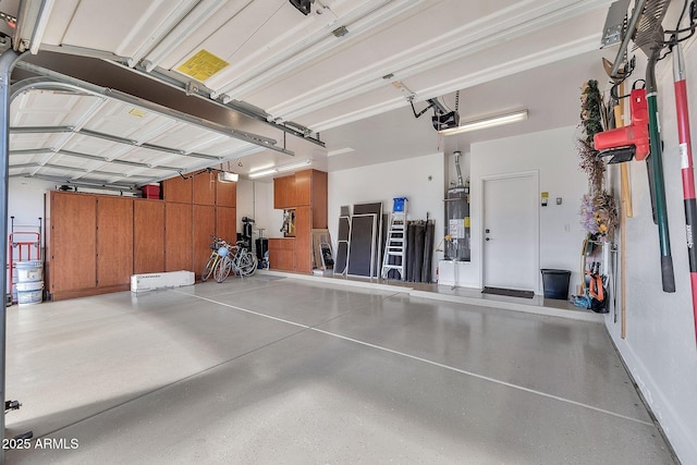 garage with secured water heater and a garage door opener