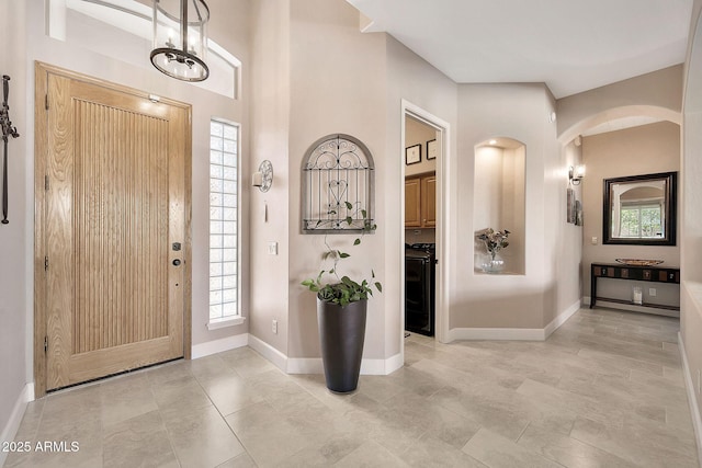 foyer entrance featuring baseboards