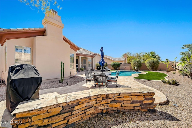 exterior space featuring a patio area, a fenced in pool, and a fenced backyard