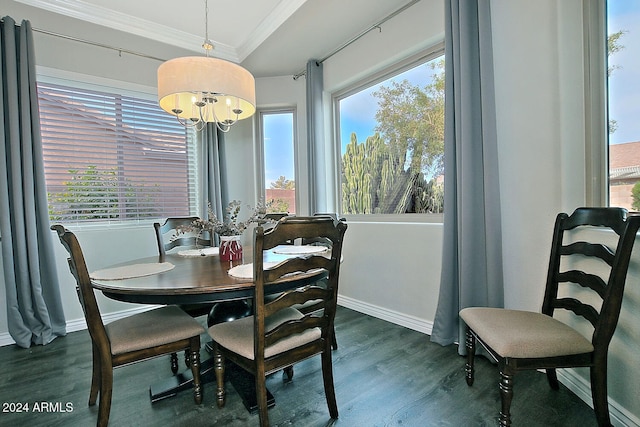 dining room featuring ornamental molding, dark hardwood / wood-style flooring, a healthy amount of sunlight, and a notable chandelier