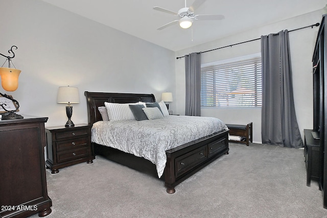 bedroom with ceiling fan and light colored carpet