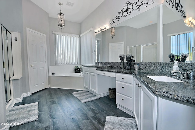 bathroom featuring vanity, wood-type flooring, and shower with separate bathtub