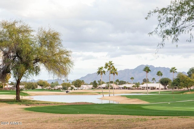 view of home's community with a yard and a water and mountain view