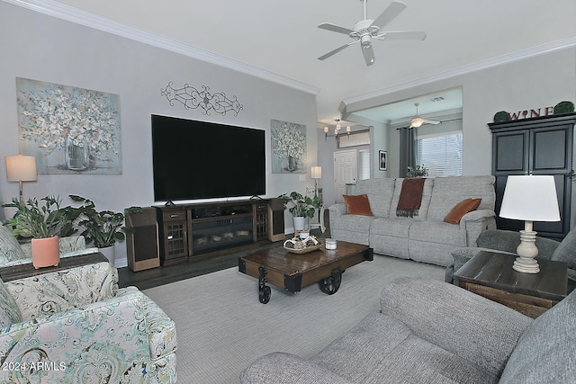 living room featuring dark hardwood / wood-style floors, ceiling fan, and crown molding