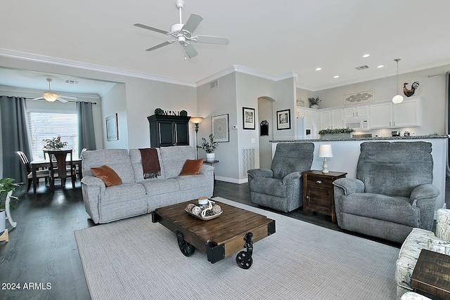 living room with ceiling fan, dark hardwood / wood-style flooring, and ornamental molding